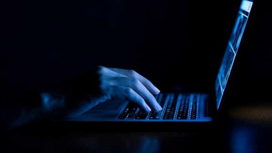 man at laptop trying to carry out a pension scam