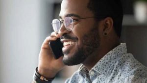 Man on the phone planning to achieve his retirement plans sooner