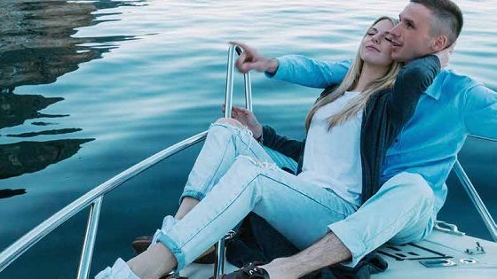 Younger couple on a boat thinking about their financial future