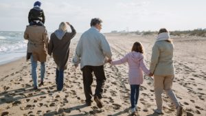 Grandparents with family on beach after thinking they would love to retire earlyWould you love to retire early