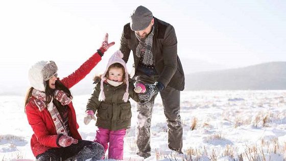 Family playing in the snow after discussing tax planning