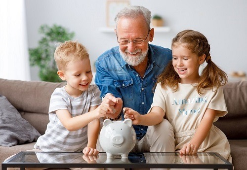 Grandfather helping grandchildren with financial planning following a meeting with a financial adviser