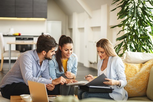 A young couple talking to an Adviser, to be provided with financial freedom